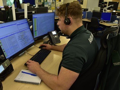 A Call Taker within an Ambulance Control Centre taking a call