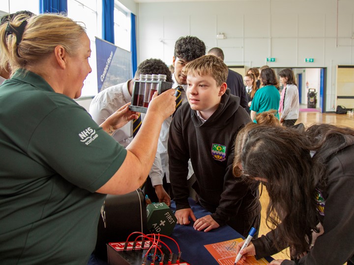 A Paramedic shows some pupils first aid