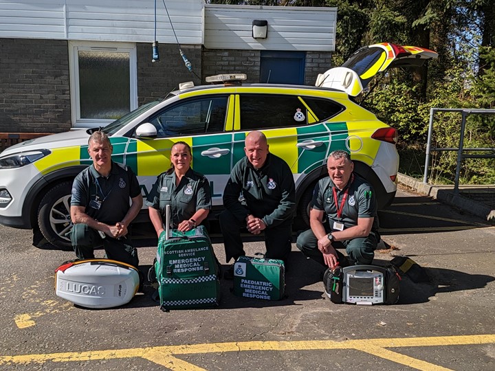 Group picture of the 3RU Responders in front of am ambulance car