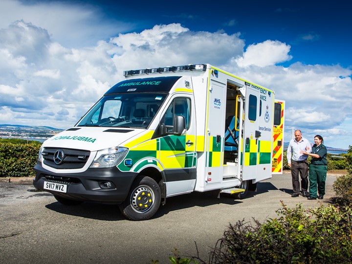 A patient is helped by a Paramedic to an ambulance