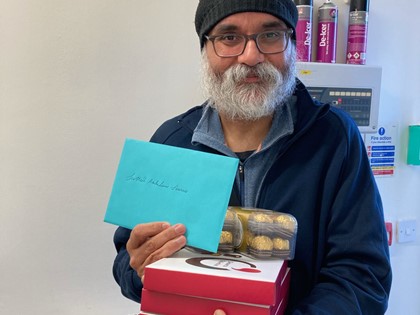 Patient Parminder with cards and chocolates for staff