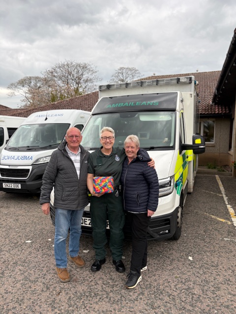 Patient Kerry Hudson stands close to Tracey, the responder who helped her, along with Kerry's husband on the other side