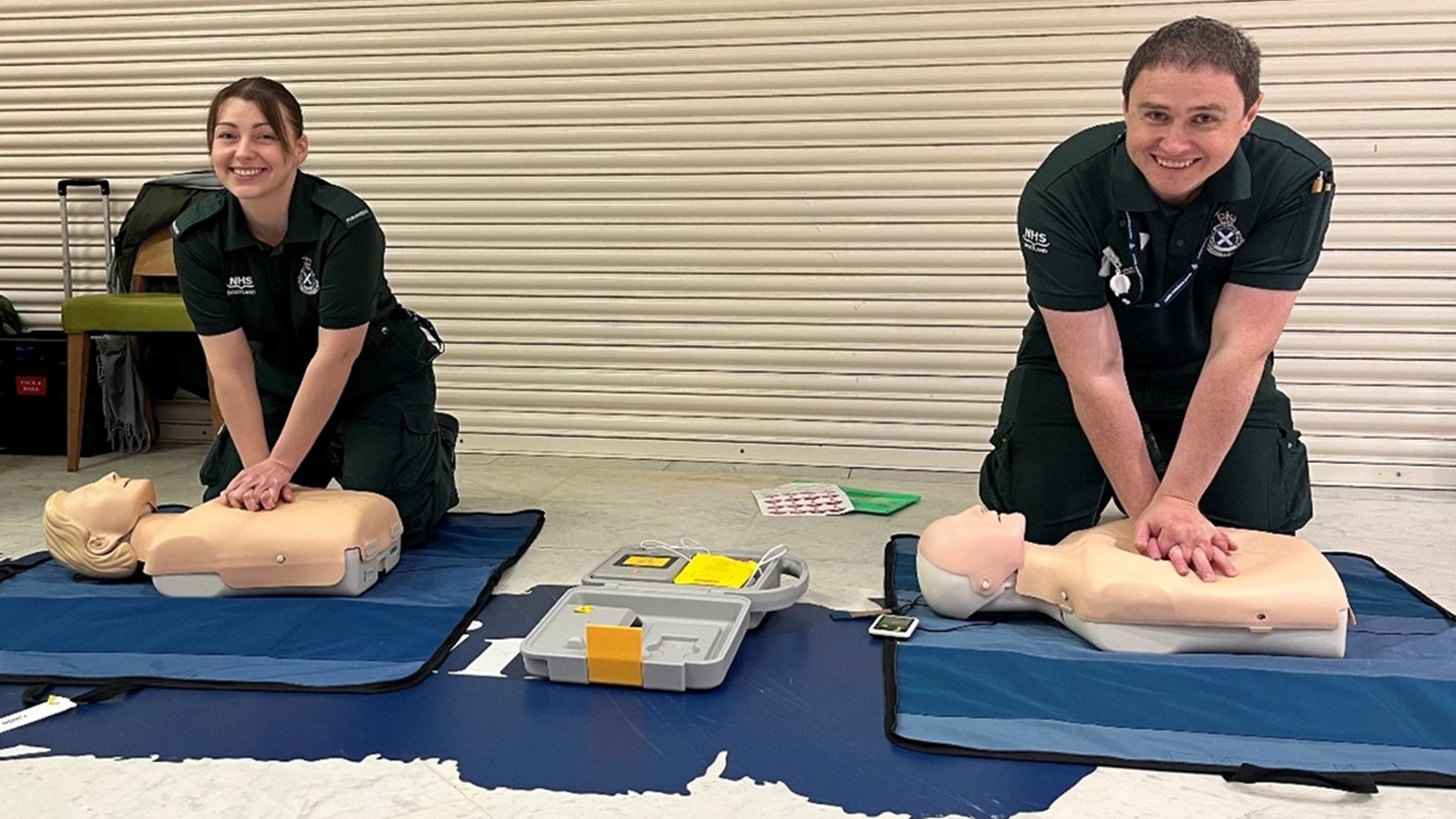 Two SAS paramedics performing a demonstration of CPR on two CPR dummies.