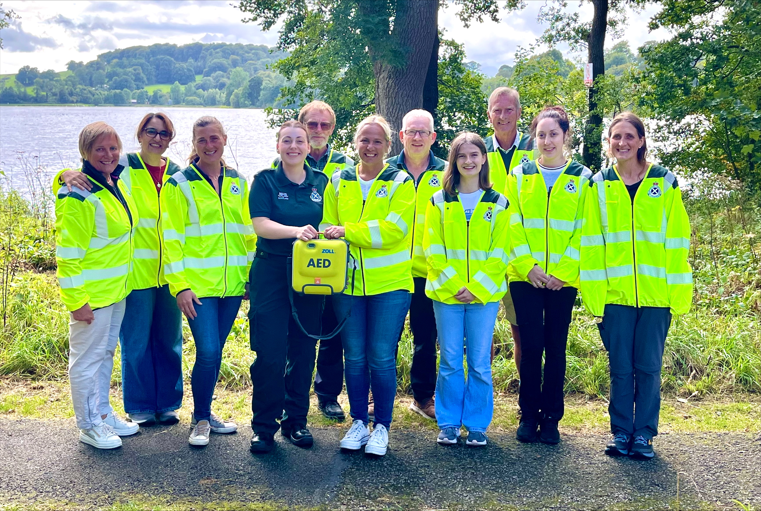 A group of 11 people - 10 community cardiac responders and a sas paramedic stood together smiling