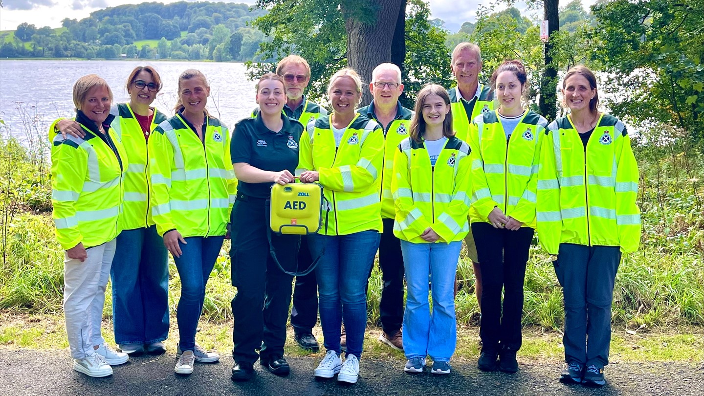 A group of 11 people - 10 community cardiac responders and a sas paramedic stood together smiling