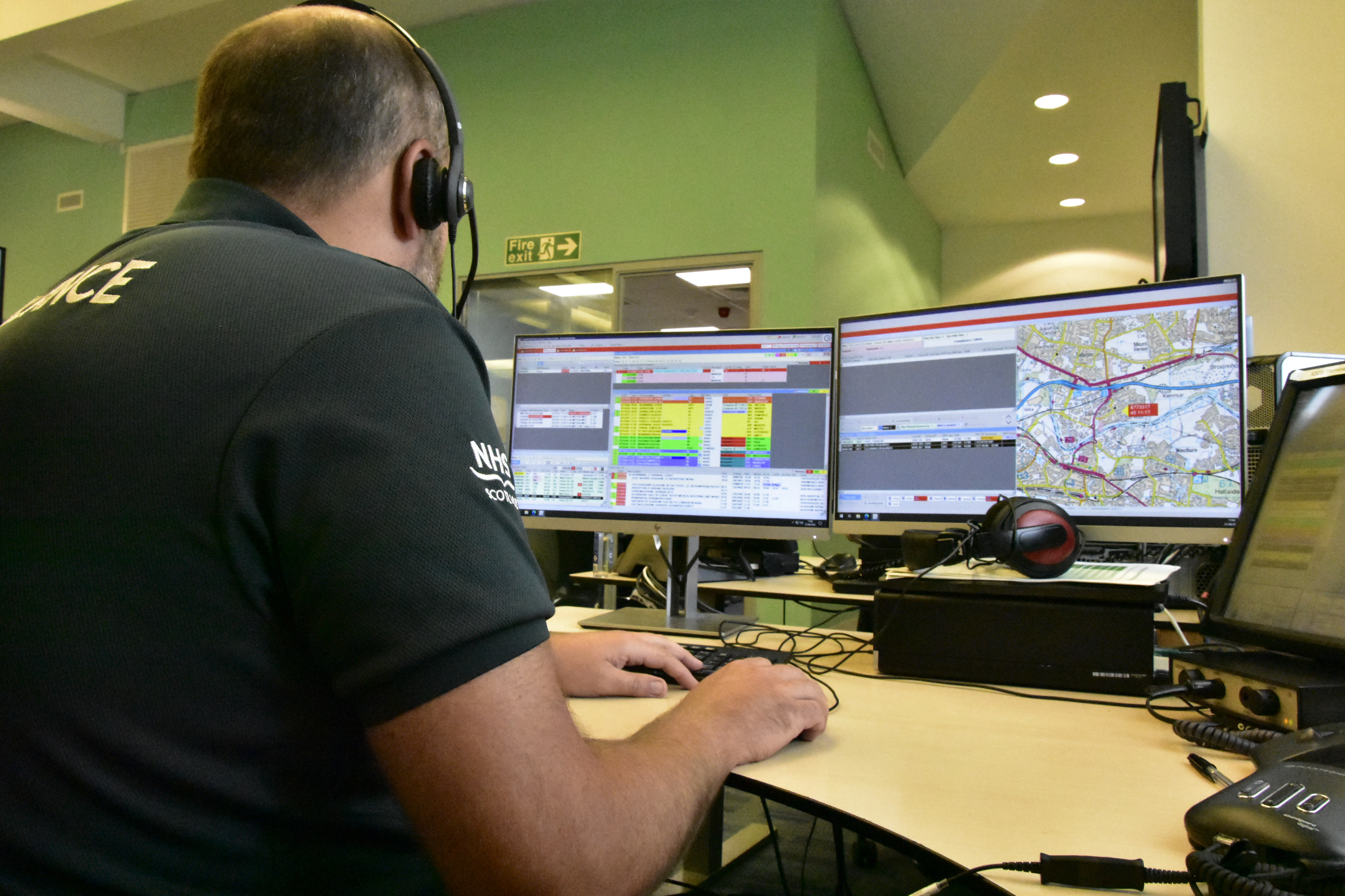 An Ambulance Call Taker looks at his computer screeen