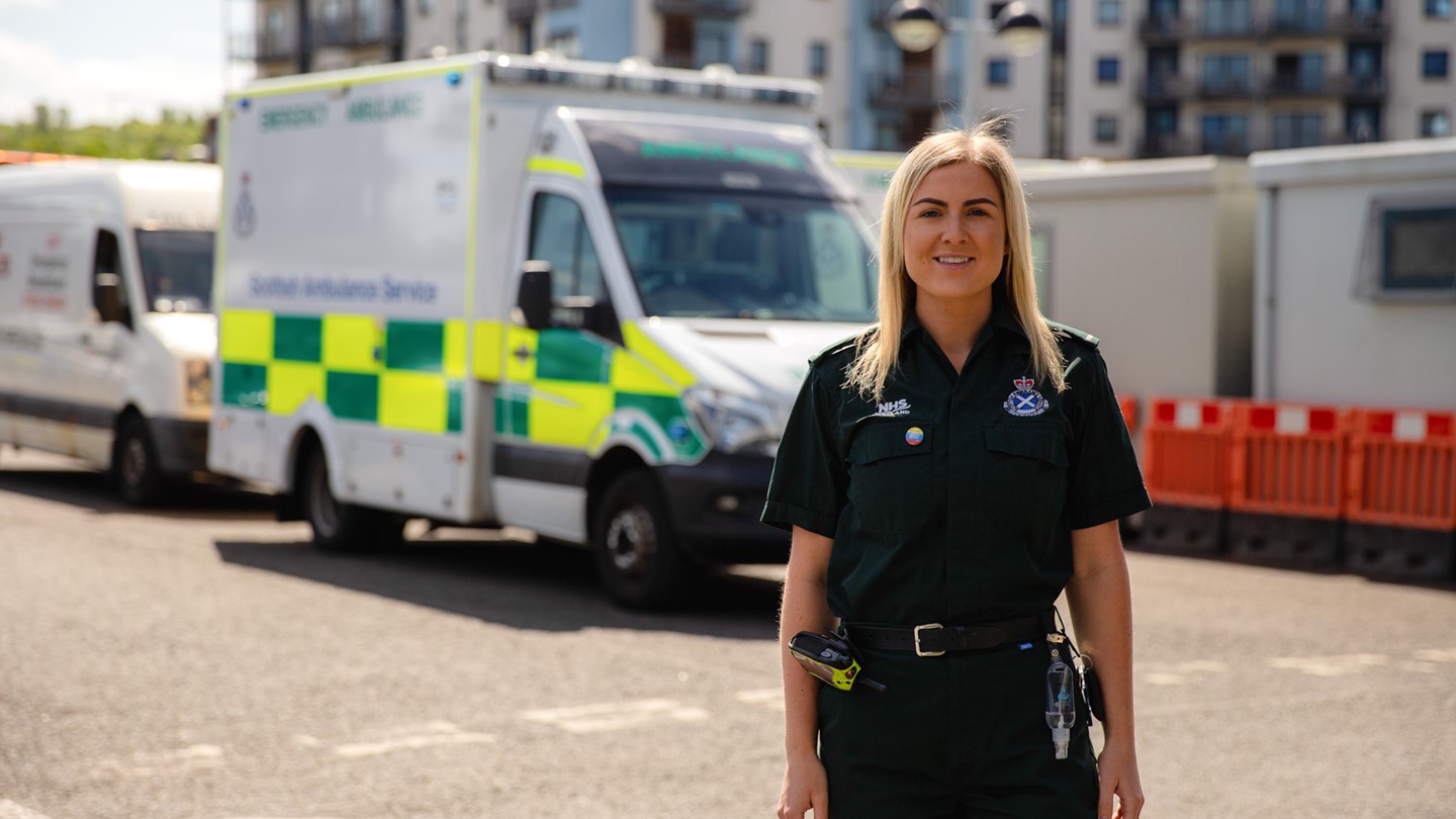 Jenifer Stewart standing in front of an ambulance.