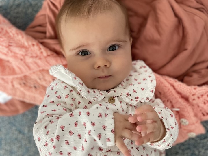 Baby Lucy Mossner looking up at the camera