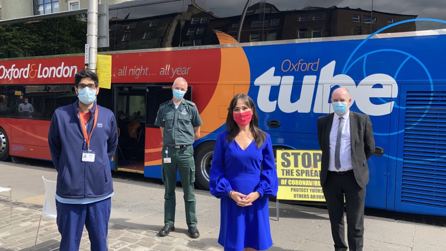 Staff in front of the Vaccine Bus