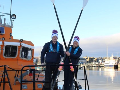 Mhairi and Allan with their row boat on the water