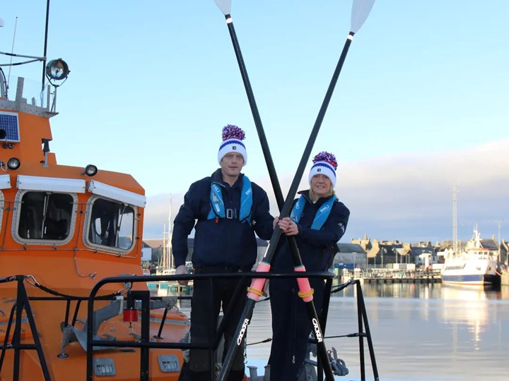 Mhairi and Allan with their row boat on the water