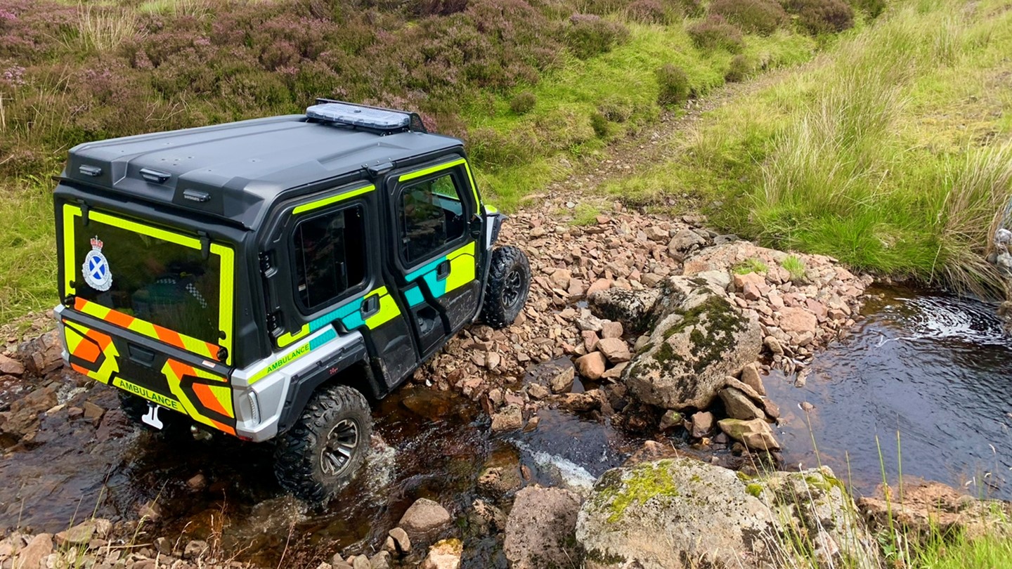 A Wolverine all terrain ambulance going across a burn