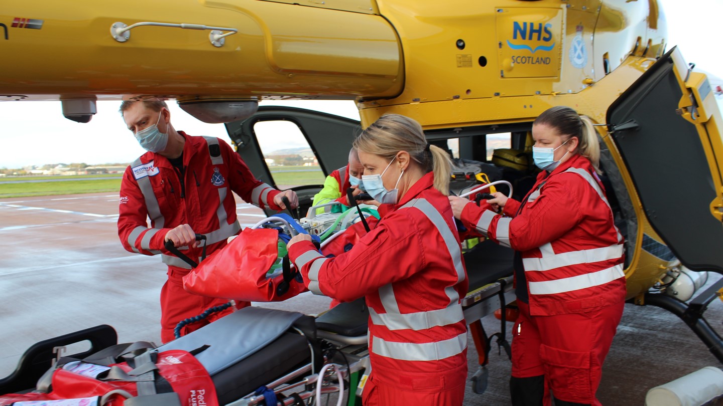 A crew take a child out of an air ambulance helicopter
