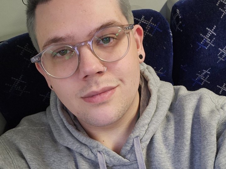 Declan takes a selfie type photo at home in his casual clothes