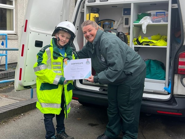 SAS staff member presenting certificate to Hector