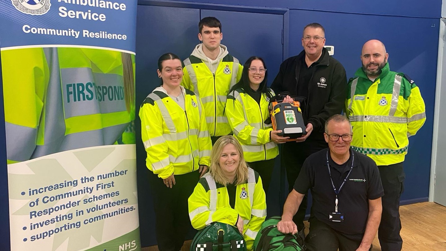 5 community first responders and 2 St John Scotland staff grouped together smiling.