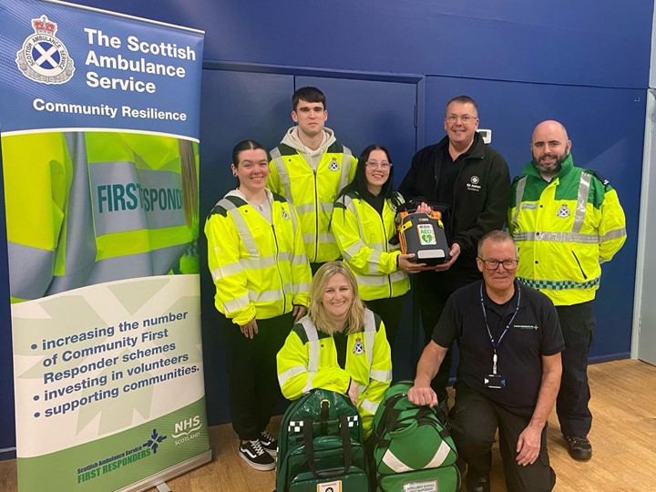 5 community first responders and 2 St John Scotland staff grouped together smiling.