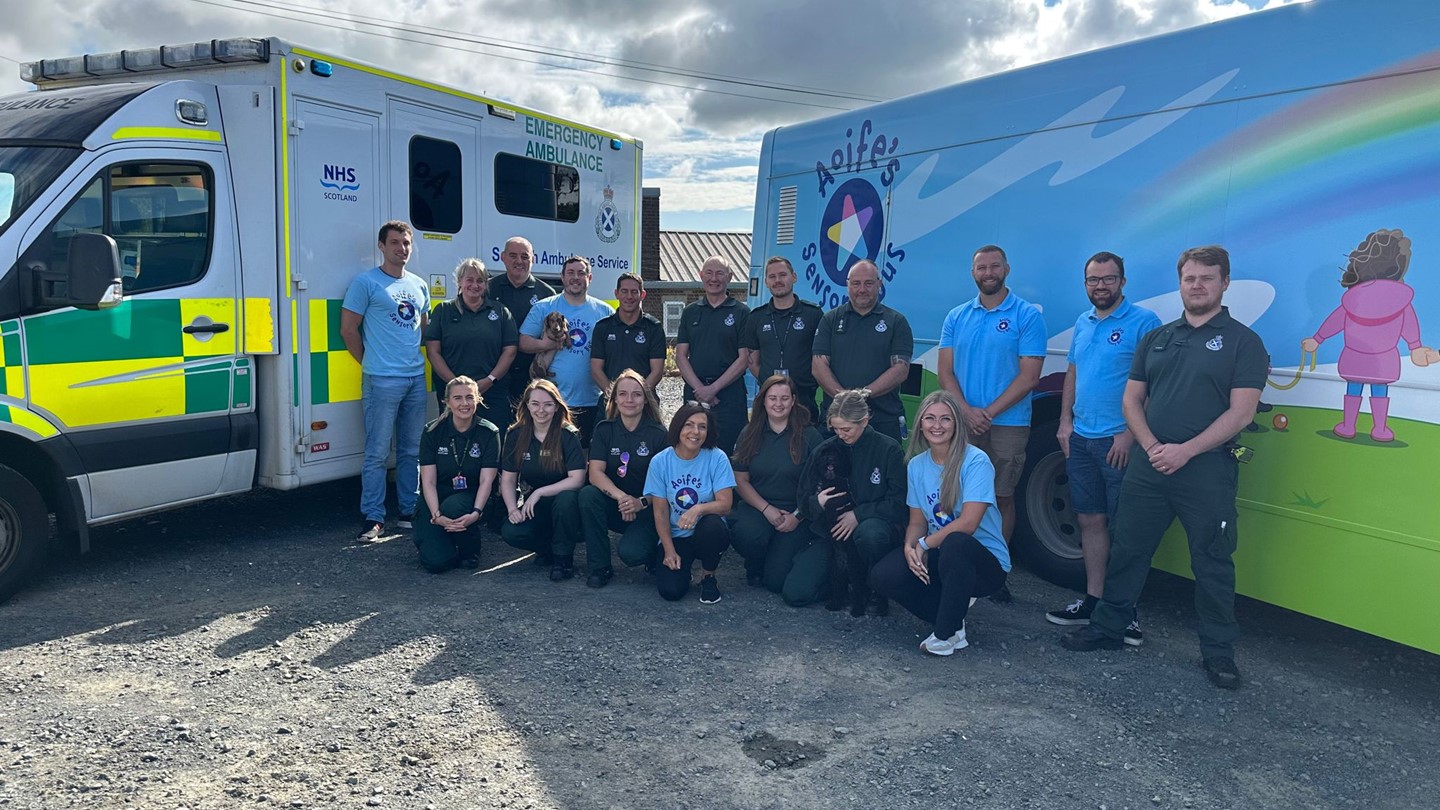 ambulance and hospital staff in front of ambulance and sensory bus