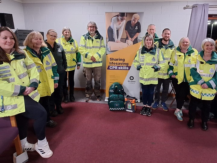 A group of 10 community first responders and one SAS crew member standing together smiling.