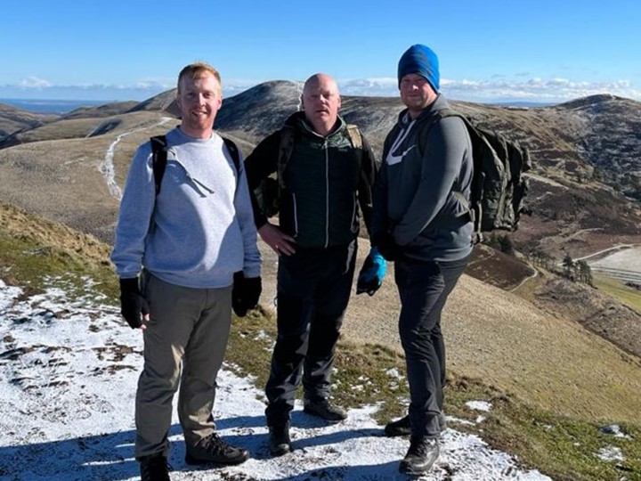 Pictured are Iain, Graeme, and Nick at the top of the Pentlands