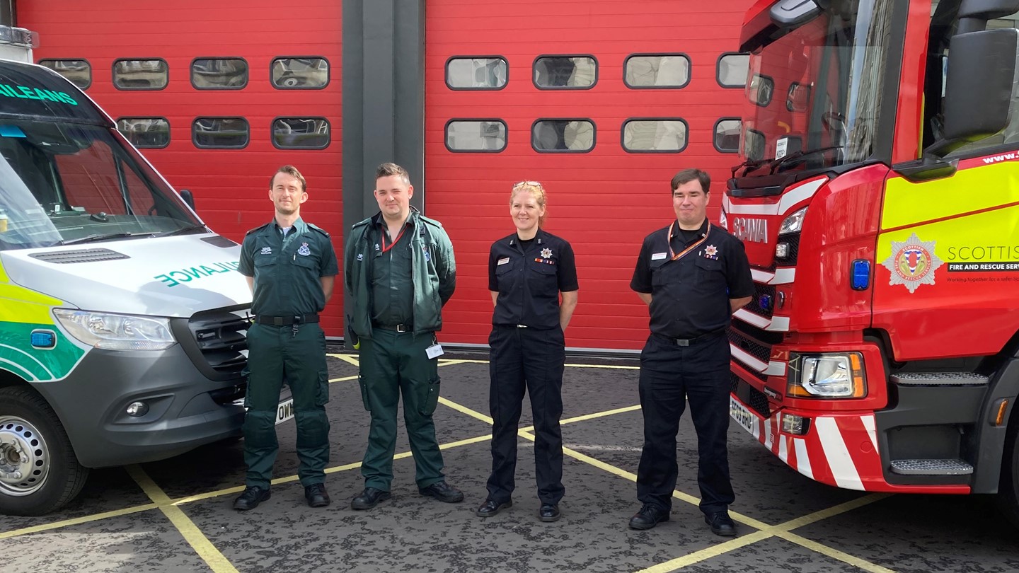 Fire and Ambulance crew in front of the station