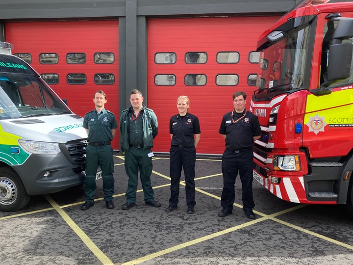 Fire and Ambulance crew in front of the station