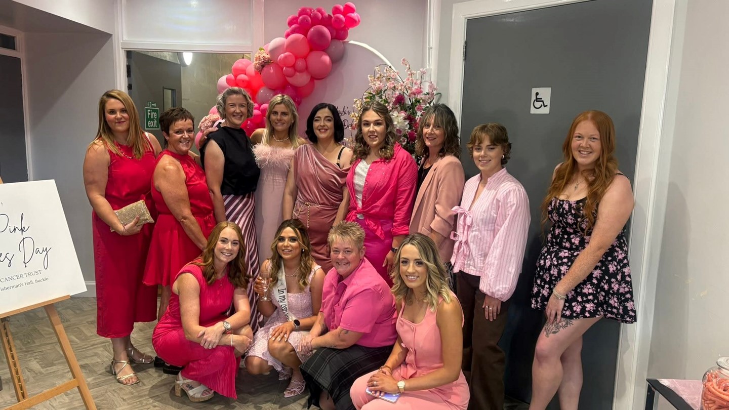 Kayla and SAS colleagues dressed in elegant pink apparel for the Ladies' Day
