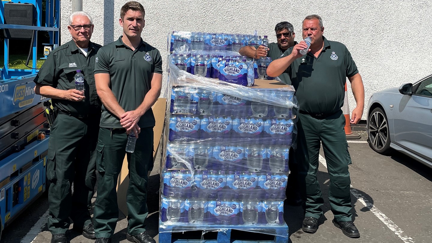 Ambulance service staff with bottles of water