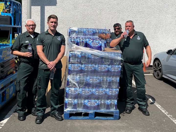Ambulance service staff with bottles of water