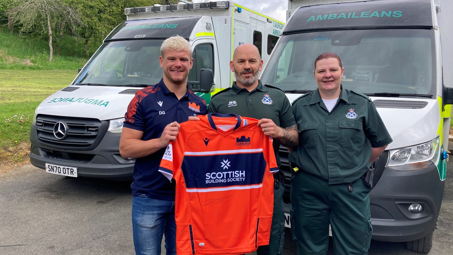 Darcy presenting signed jersey to Hawick staff members