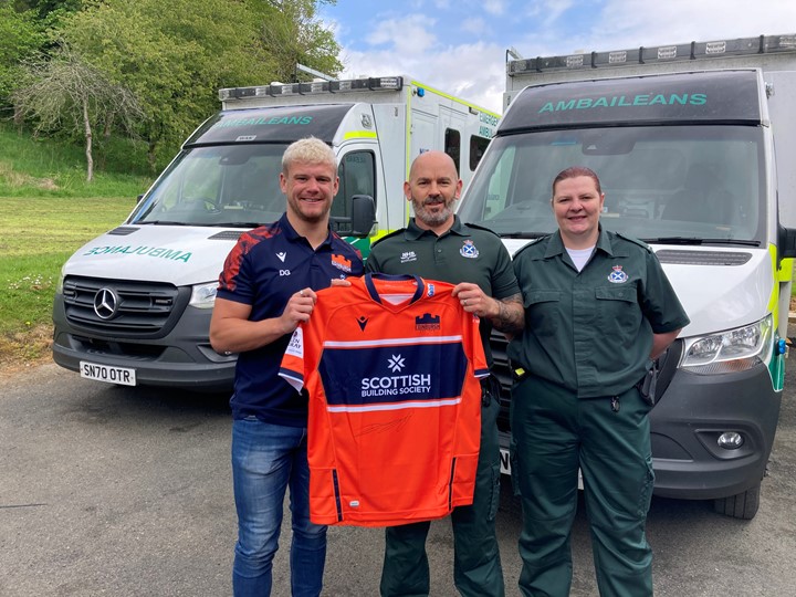 Darcy presenting signed jersey to Hawick staff members