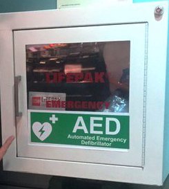 A white cupboard for a public access defibrillator