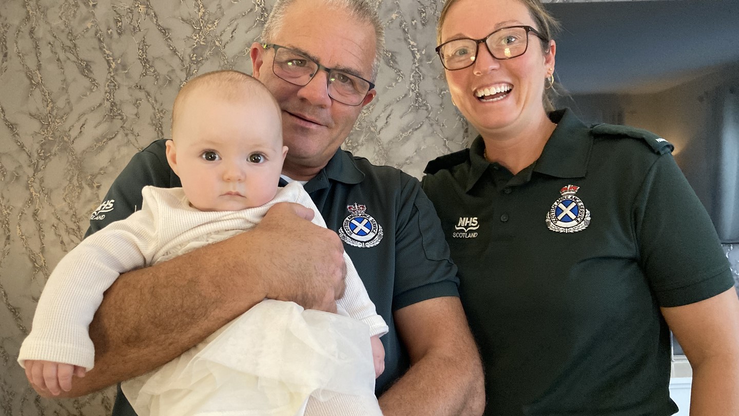 Dale and Emma delighted to be holding baby Bonnie in uniform
