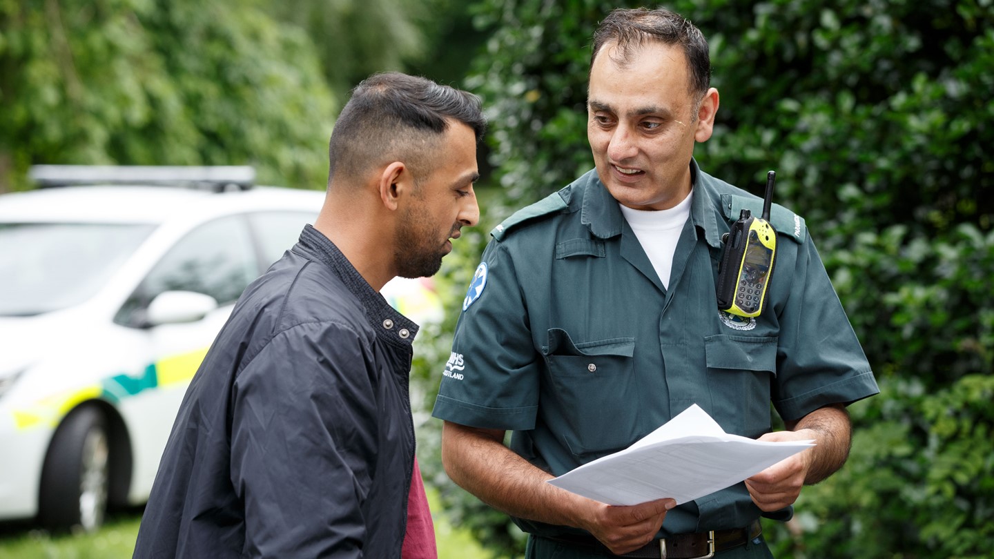 A Paramedic talks to a member of the public