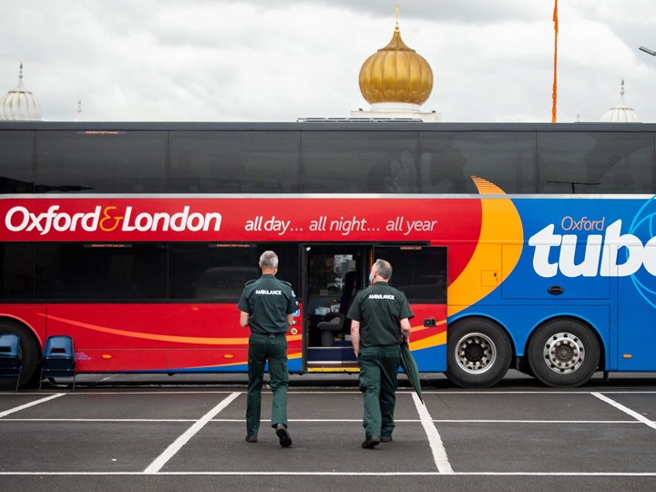 Two paramedics outside a bus