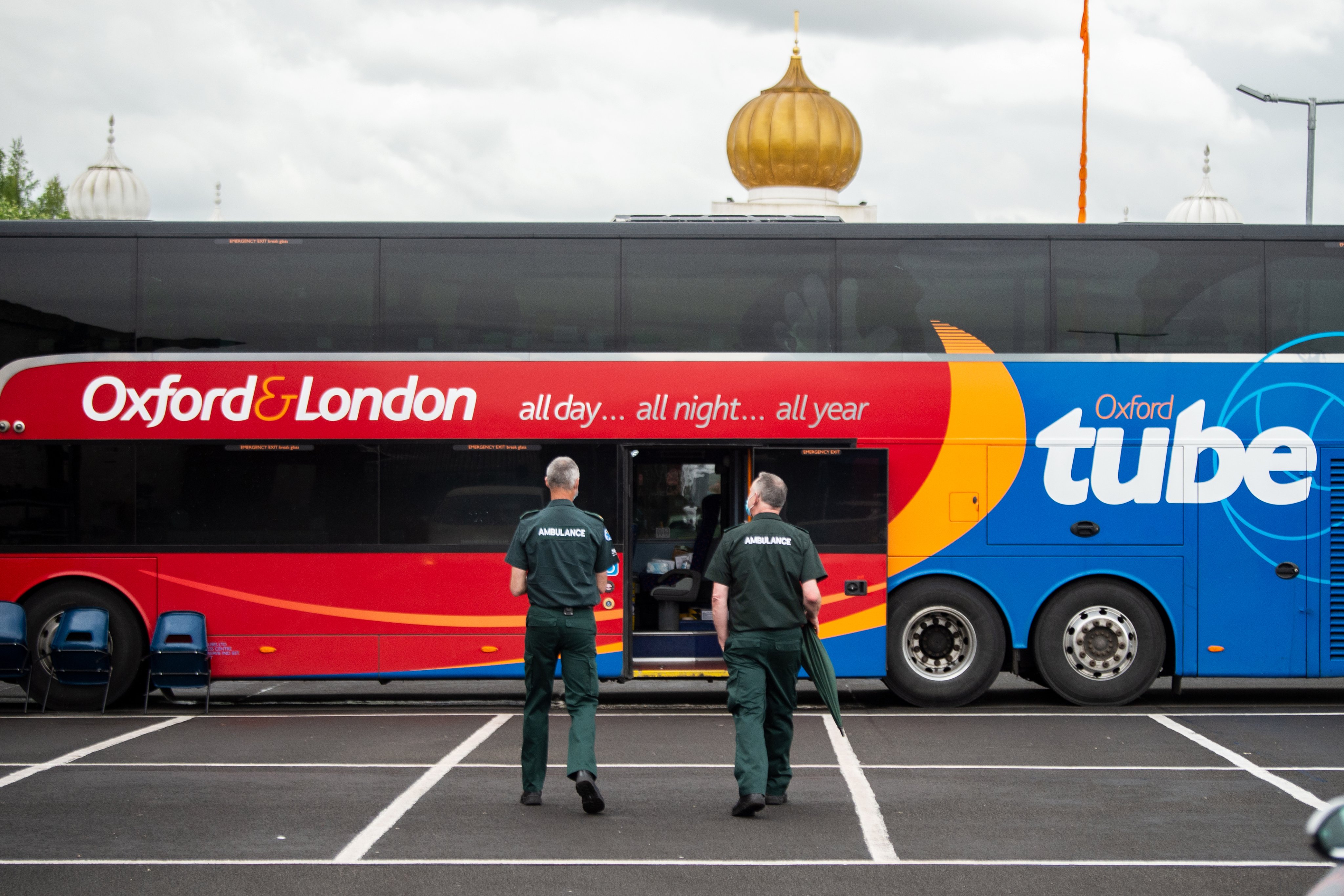 Two paramedics outside a bus