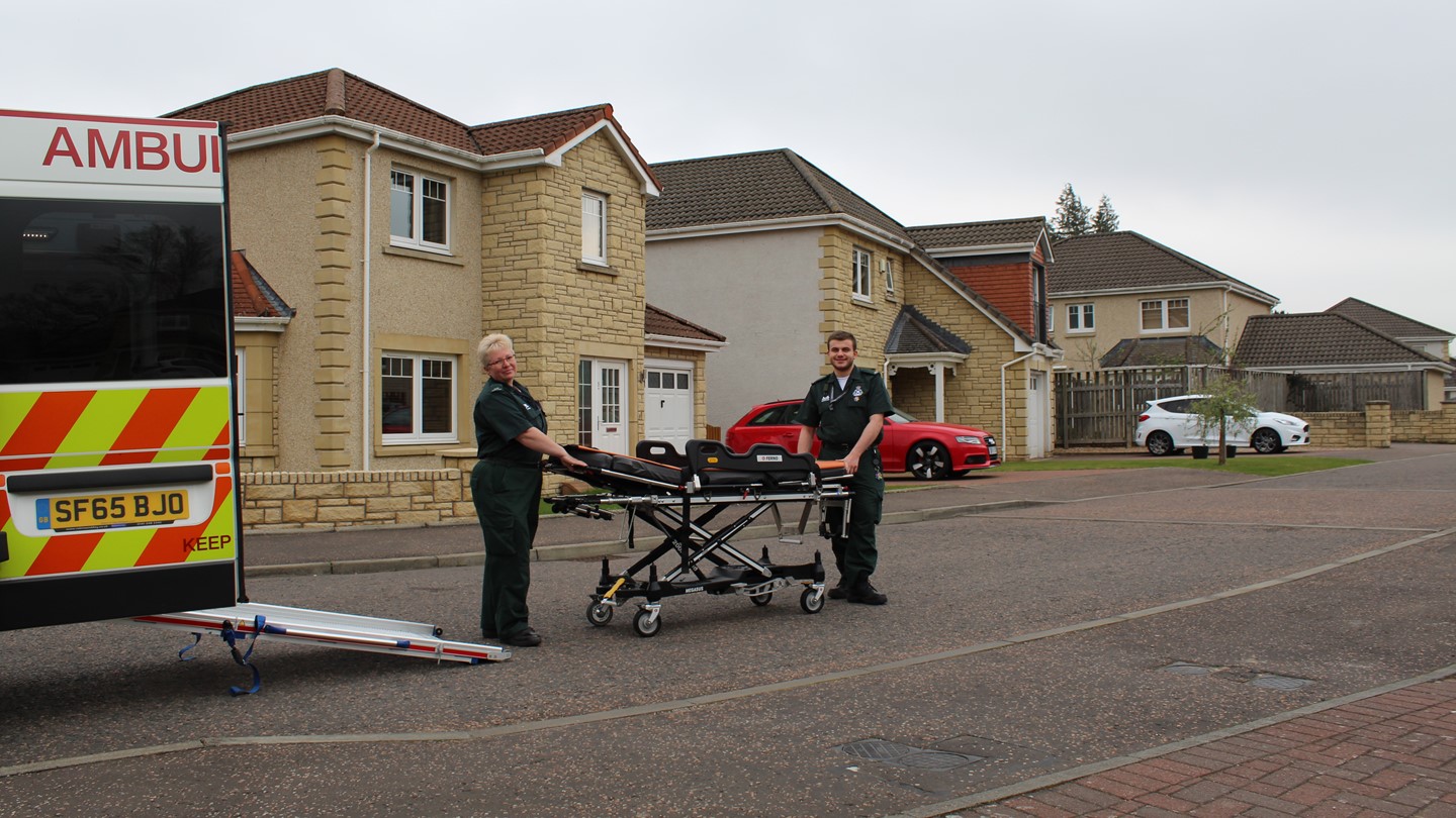 Two ambulance Care Assistance's with a stretcher