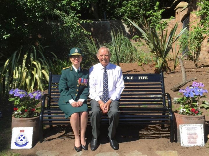 Pauline Howie with another attendee sitting on a bench in the memorial garden