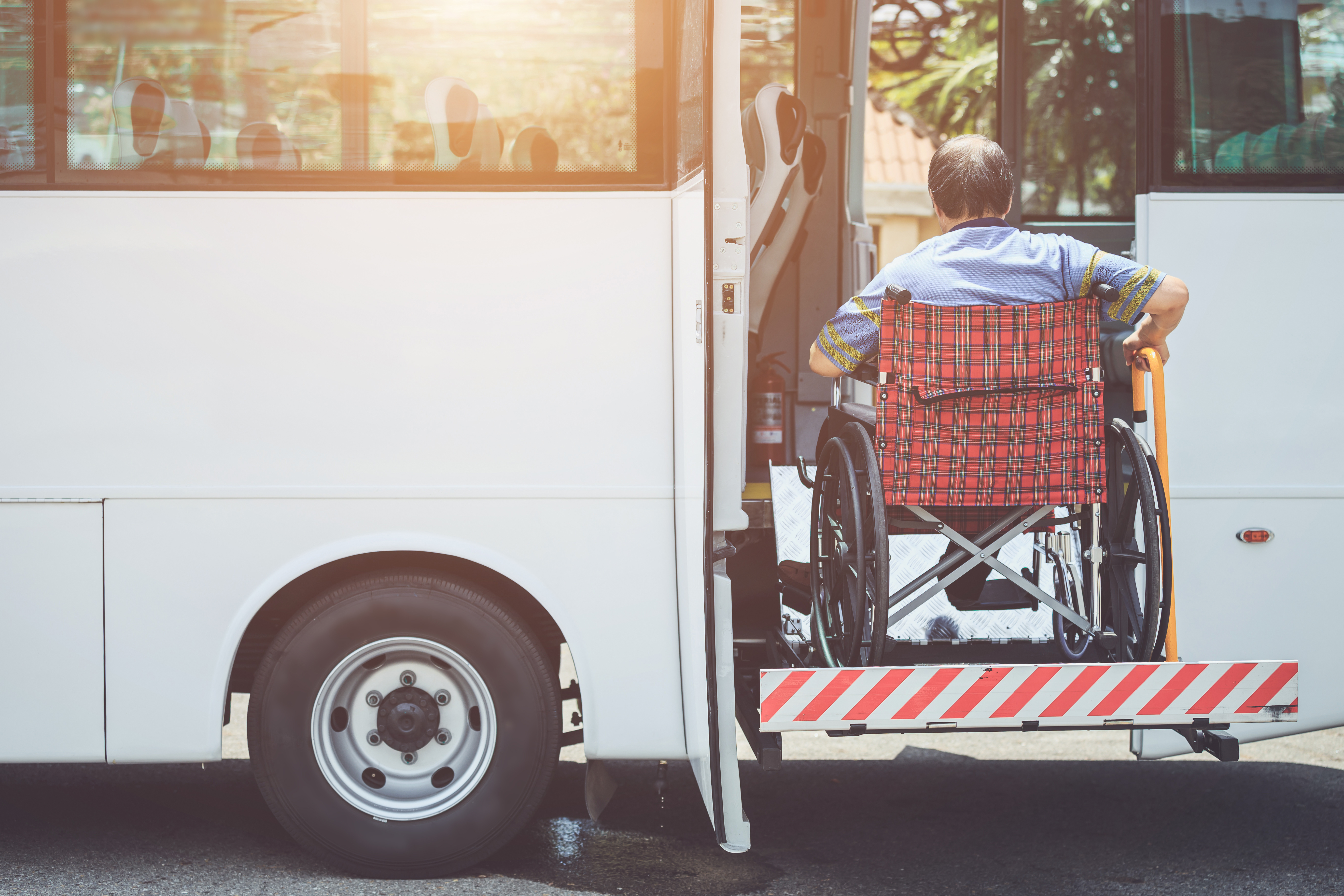 A man in a wheelchair boarding a bus