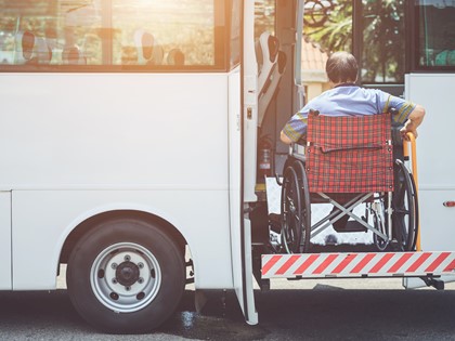 A man in a wheelchair boarding a bus