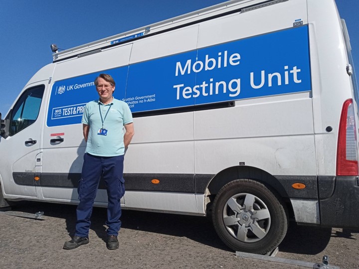 Marcus Spinks in front of a mobile testing unit van