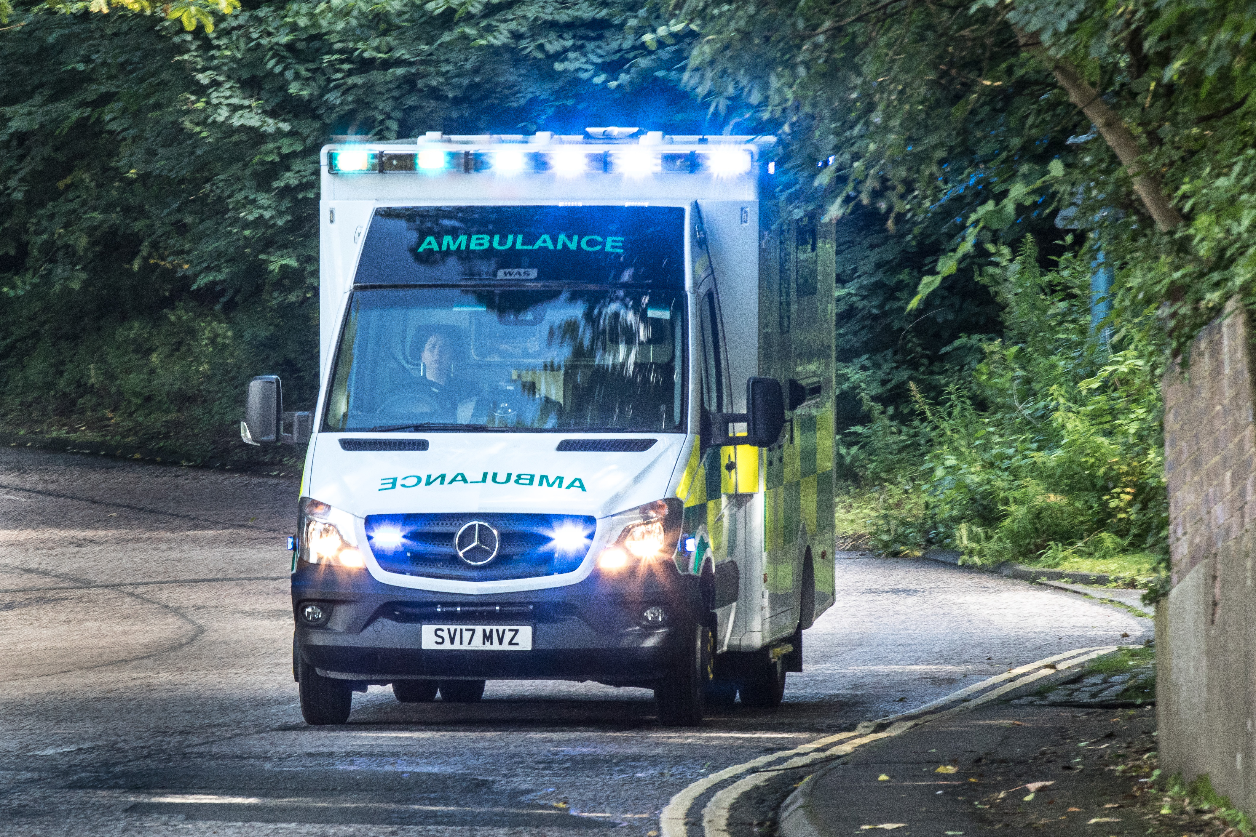 Front view of SAS ambulance on blue lights driving to a job