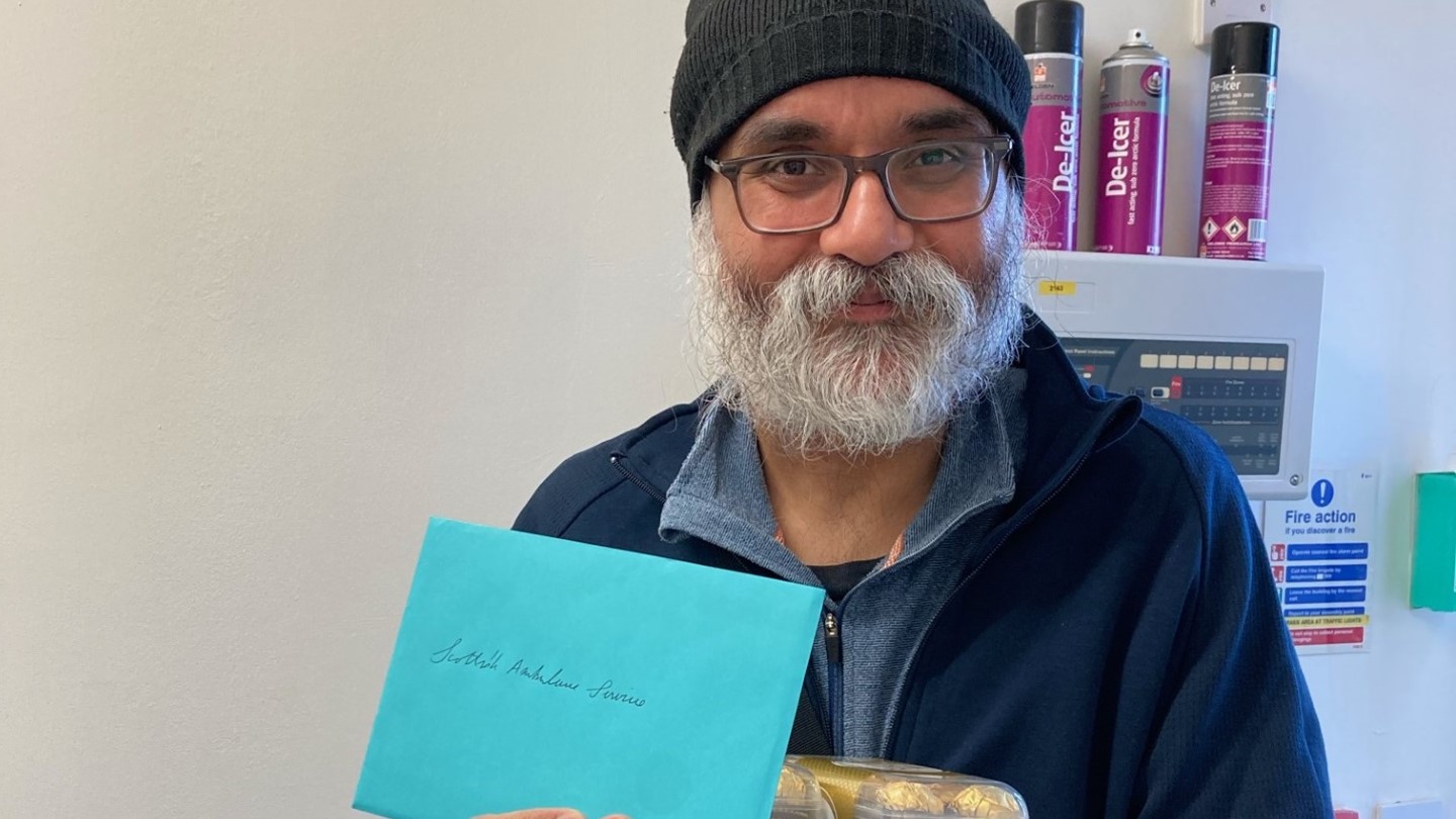 Patient Parminder with cards and chocolates for staff
