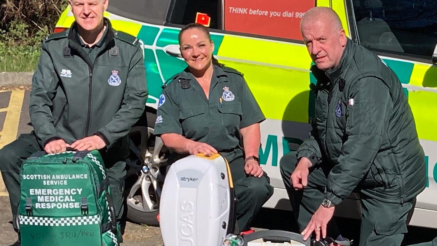 Group shot of 3RU responders in front of an ambulance car